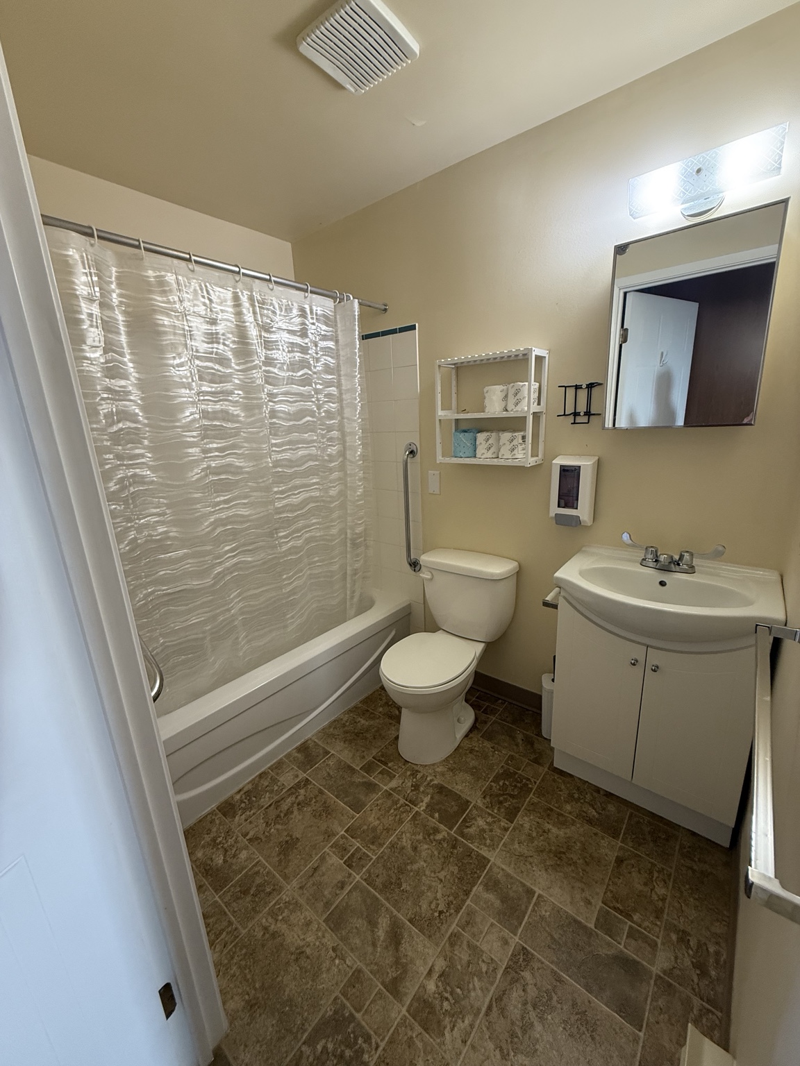 Bathroom with a shower, toilet, and sink at the Delhi centre