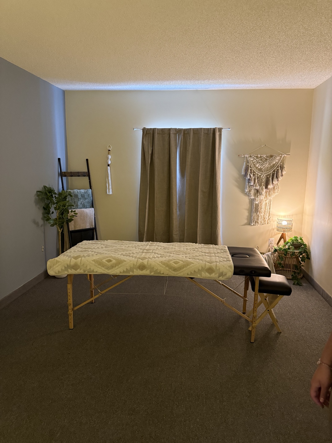 Massage room with a massage table, warm lighting and plants at the Delhi centre